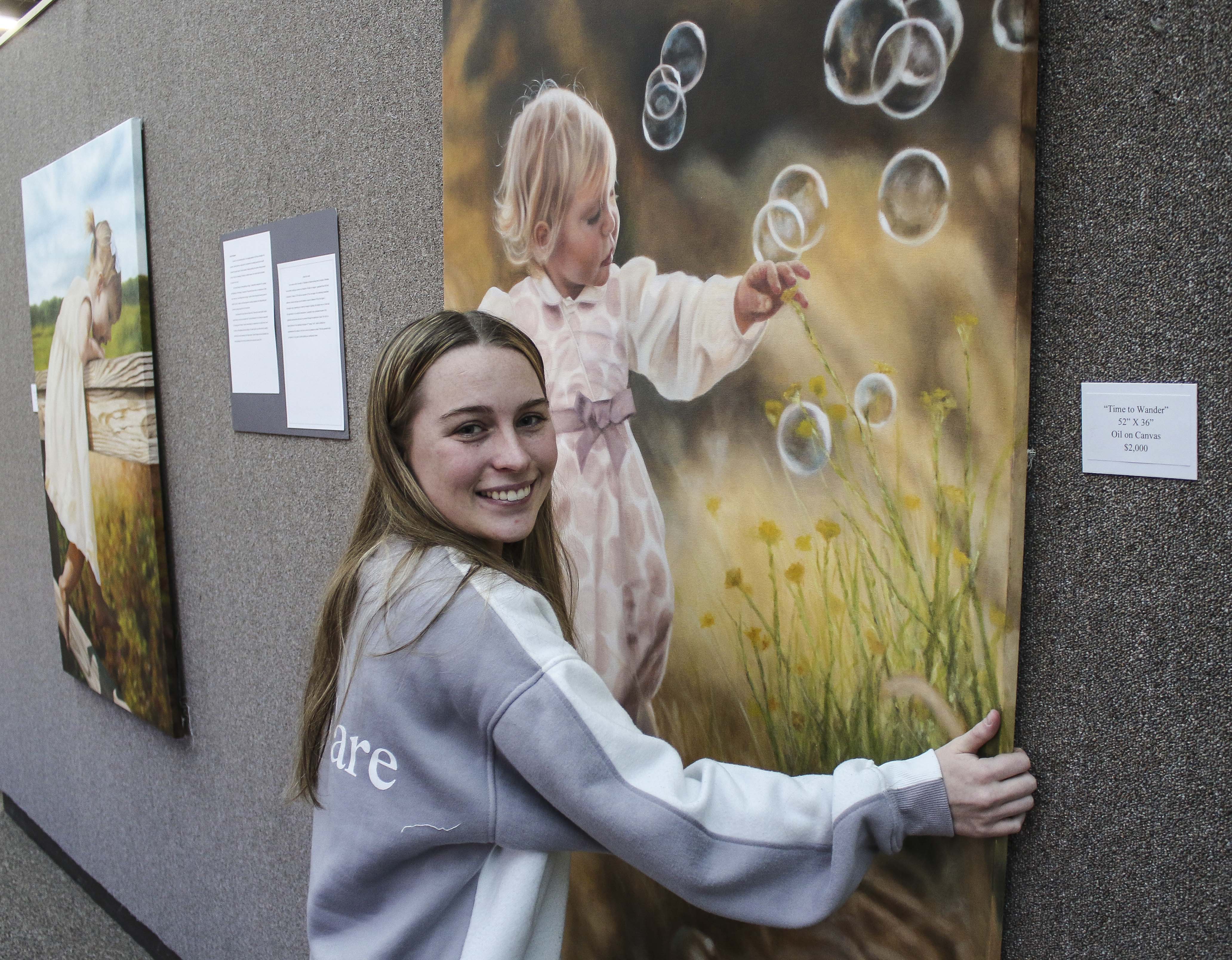 MCC freshman Macey Johnson helps set up an exhibit in the Wrightstone Gallery featuring her former Lexington High School classmate Hana Brock, a 2020 graduate of MCC.