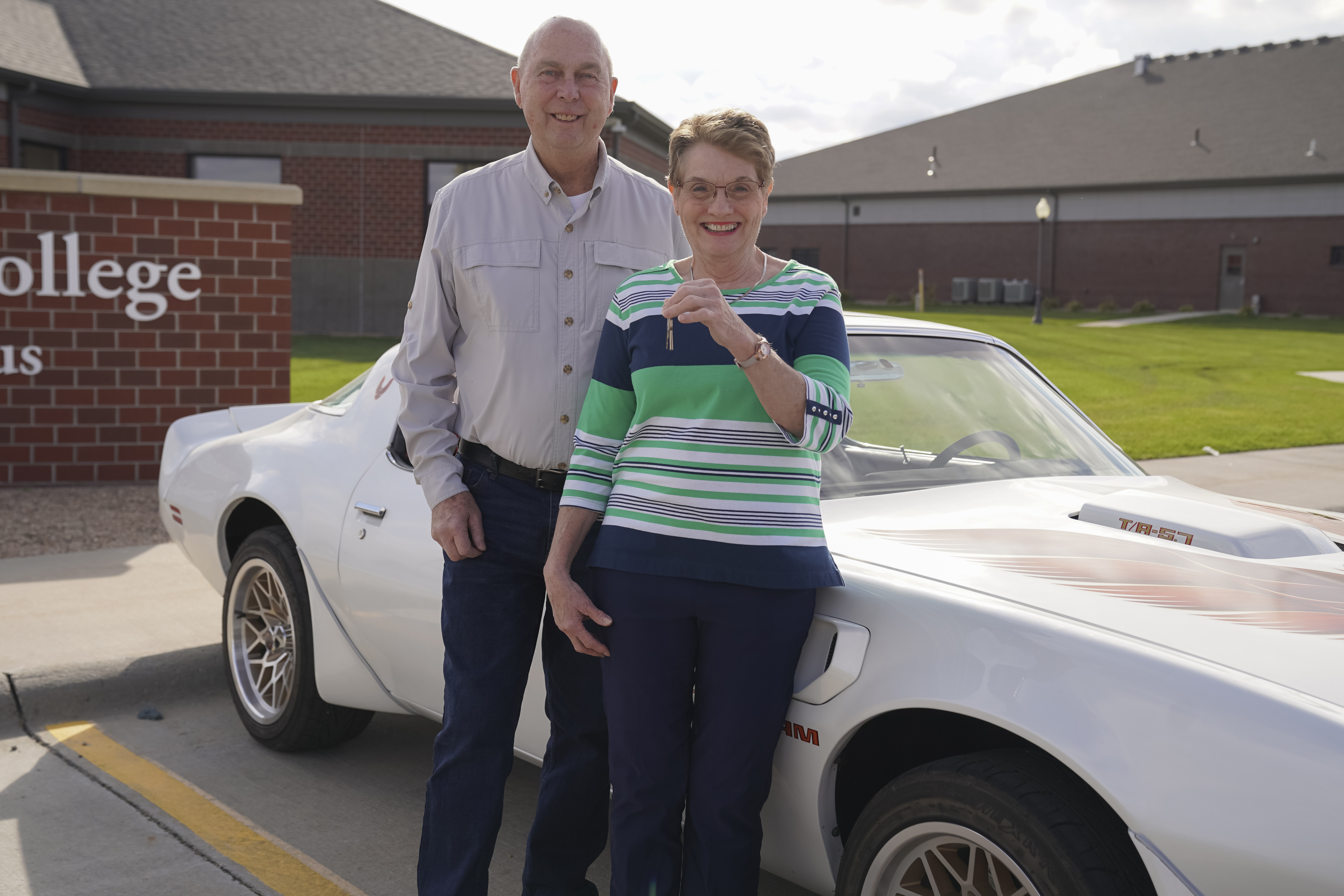 Nancy and Stan Sedlacek stand in front of their 1979 Pontiac Trans Am at the Mid-Plains Community College Broken Bow Campus on Monday afternoon.